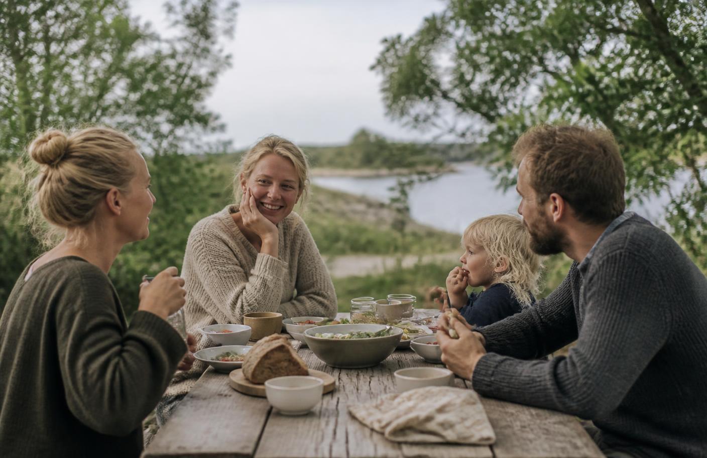 People sharing a simple meal outdoors in natural daylight